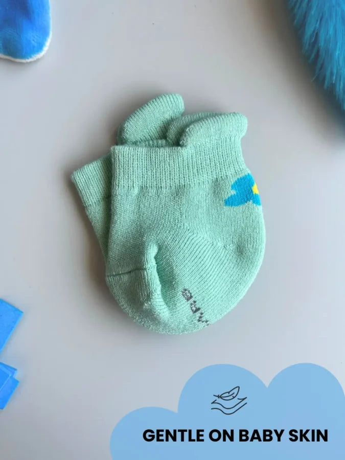 Air Garb brand baby combo socks for infants 0-1 years; a 6-pair collection arranged in a circle featuring three pairs with side flower designs (pink, yellow, mint) and three pairs with kitten face cuffs (purple, lime green, blue).